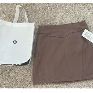 Lululemon scuba HR mini skirt with a Lululemon shopping bag size M